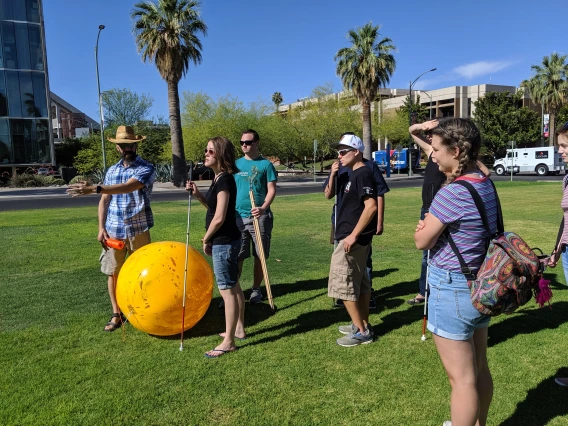 Dr. Kortencamp and POEM students on UA mall during solar system modeling