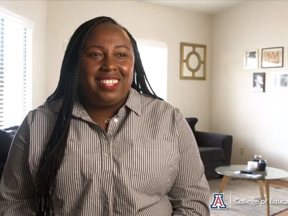 young african american woman with long hair sitting in living room setting