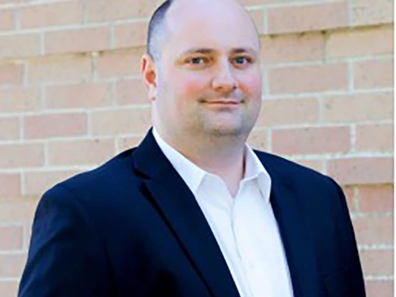 Andy Shaner, male wearing white shirt and dark blue blazer