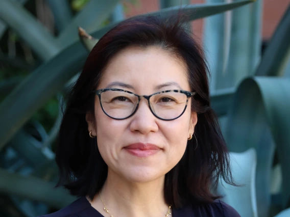 jenny lee headshot, wearing eyeglasses, black blouse, in front of agave plant