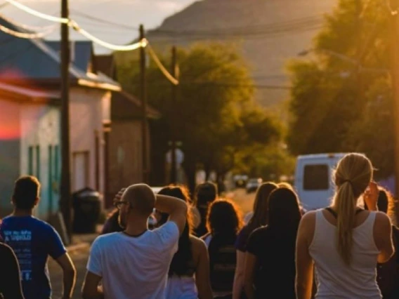 border sunset with people walking in the street