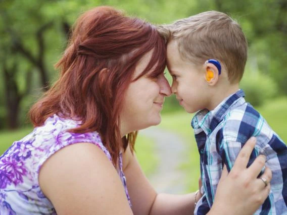 woman with little boy in hearing aids