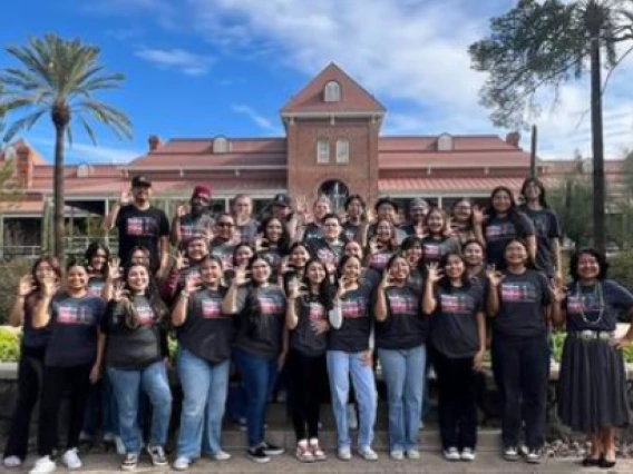 native soar group photo standing in front of old main on ua campus under a sunny sky