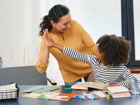 African American girl with autistic disorder with child's psychologist while psychological treatments for kid