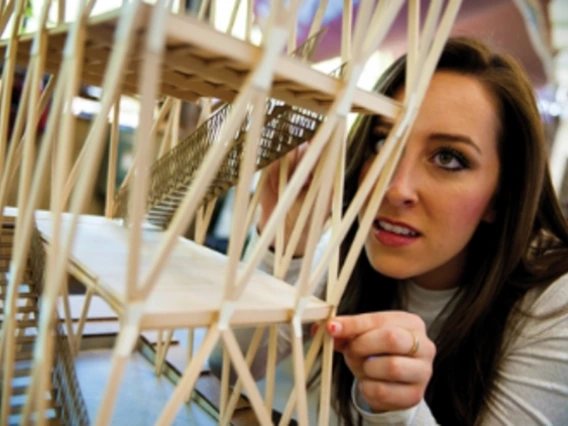 adult student working on a stick architectural project