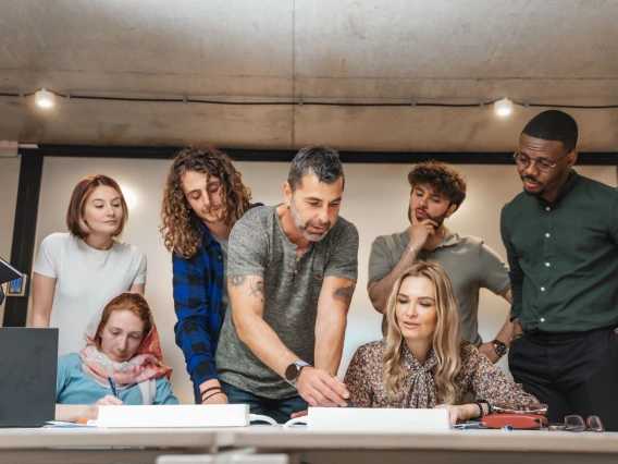 group of adult professionals at a desk