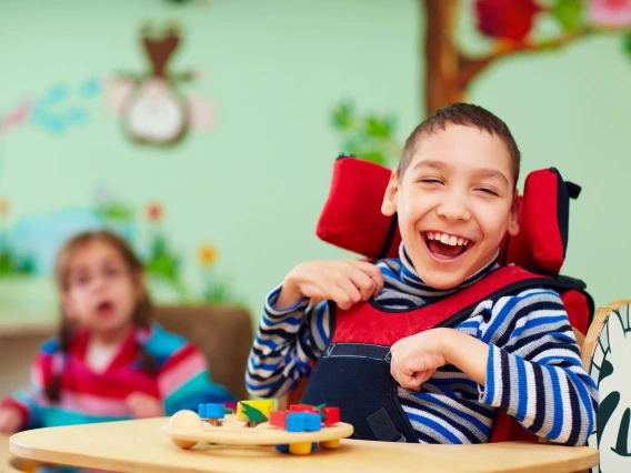 cheerful boy with disability at rehabilitation center for kids with special needs