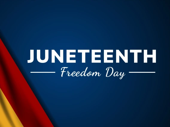 Graphic with a dark blue background featuring the words ‘JUNETEENTH’ in bold white capital letters and ‘Freedom Day’ in white cursive below. On the left side, red, gold, and green vertical stripes evoke the Pan-African flag colors.