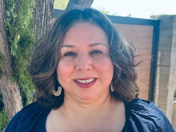 Dr. Hortencia Cota smiling while holding her 2024–2025 ASA Distinguished Administrator of the Year award for the Higher Education Division, presented by Arizona School Administrators.