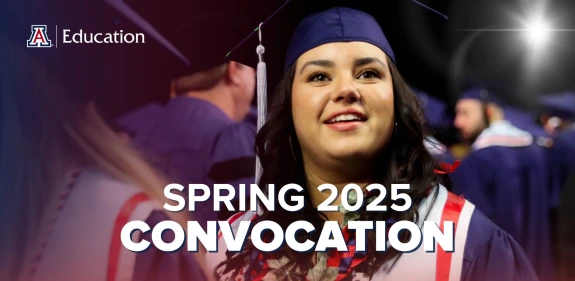 Graduating student in cap and gown smiling during the University of Arizona College of Education Spring 2025 Convocation ceremony, with other graduates in the background.