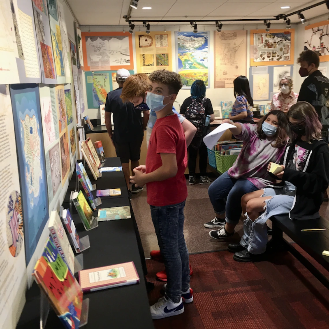 several patrons browsing a library exhibit