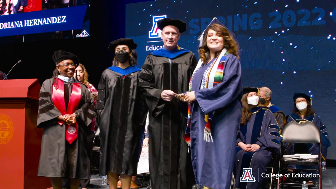 karla crespo receiving diploma on graduation stage from dean johnson