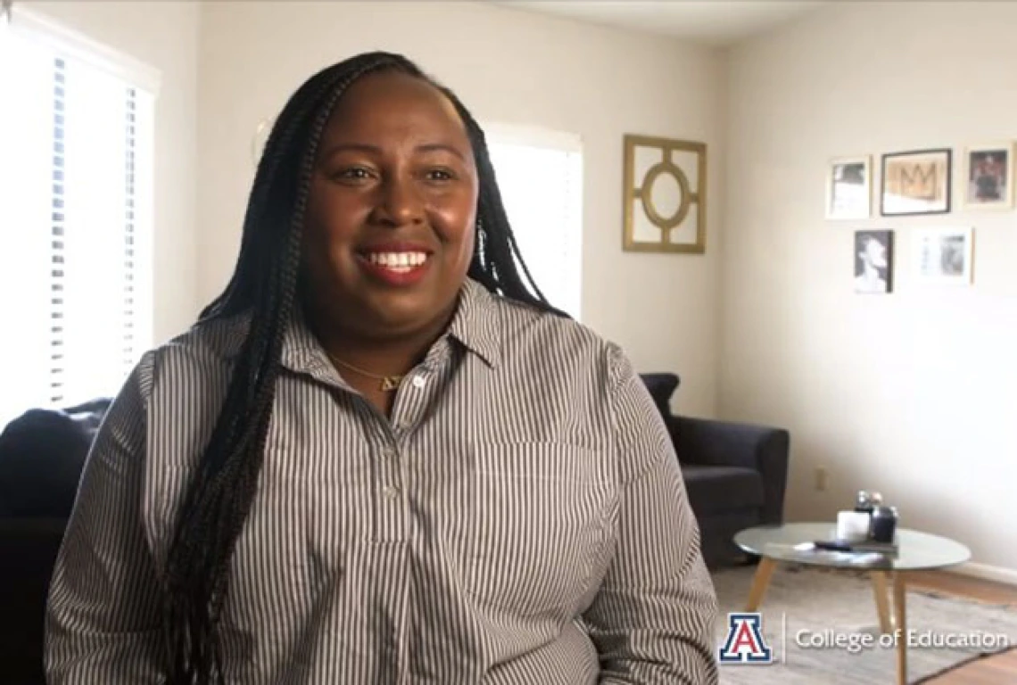 young african american woman with long hair sitting in living room setting