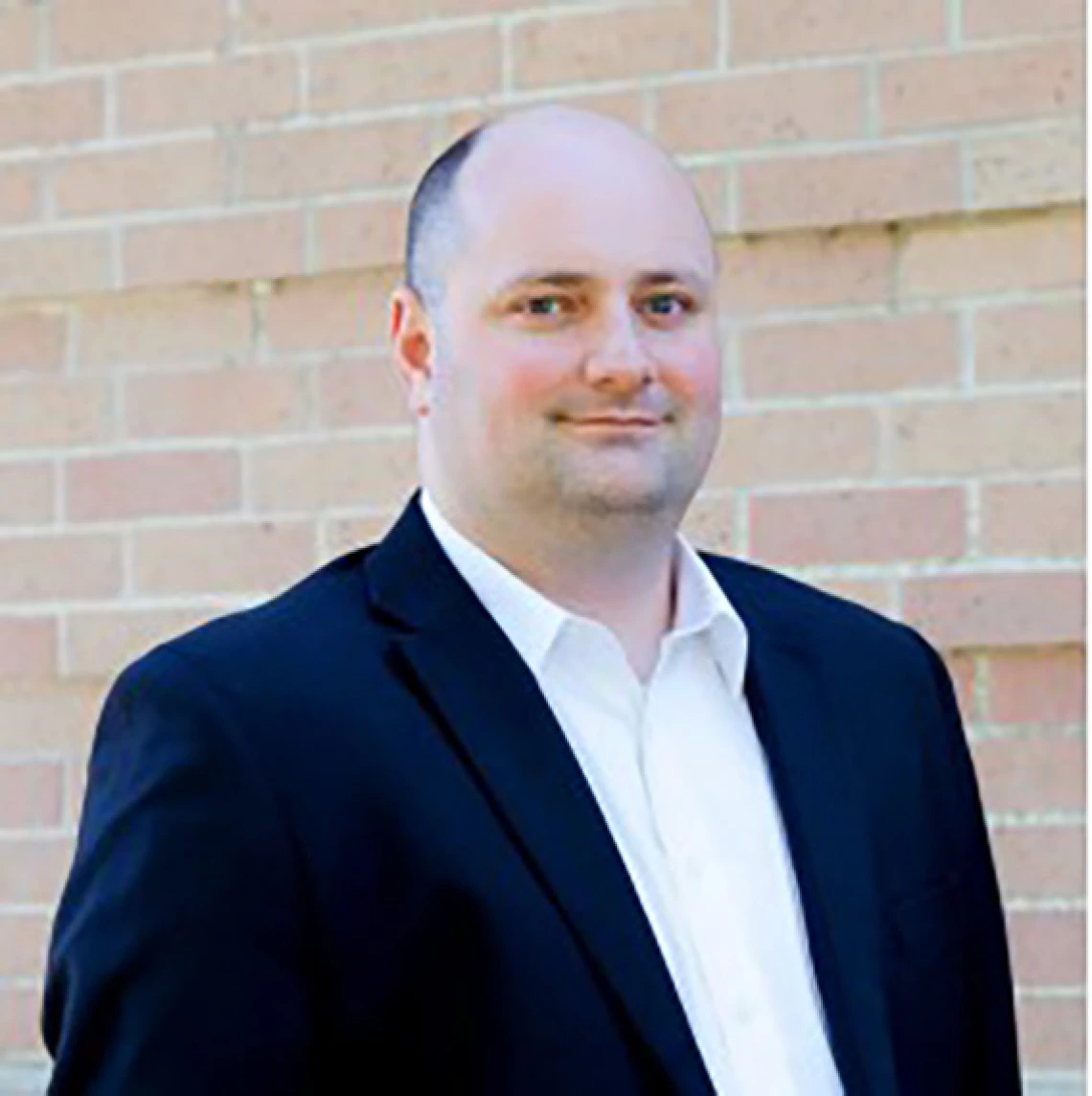 Andy Shaner, male wearing white shirt and dark blue blazer