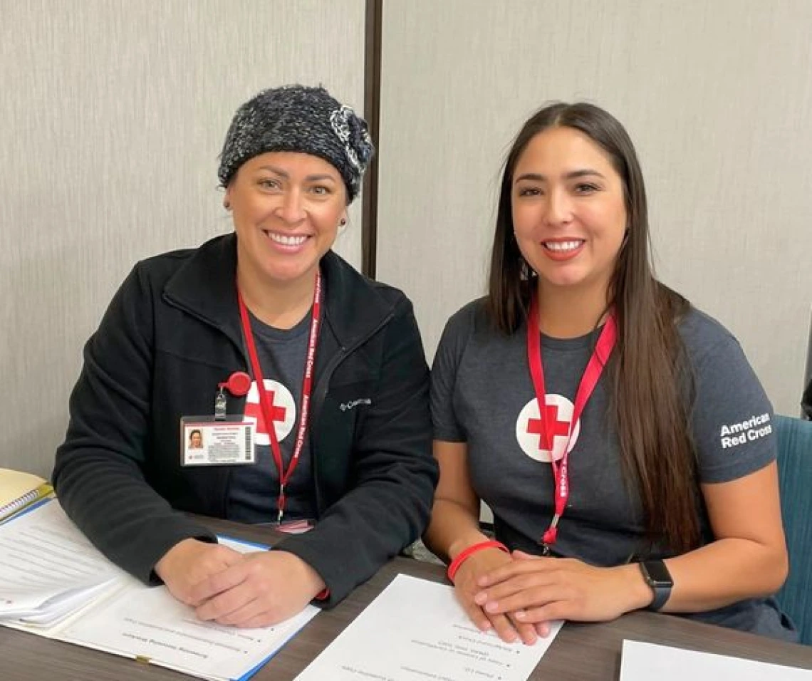 professor vannesa perry and graduate student stephanie moller sitting side by side at a table