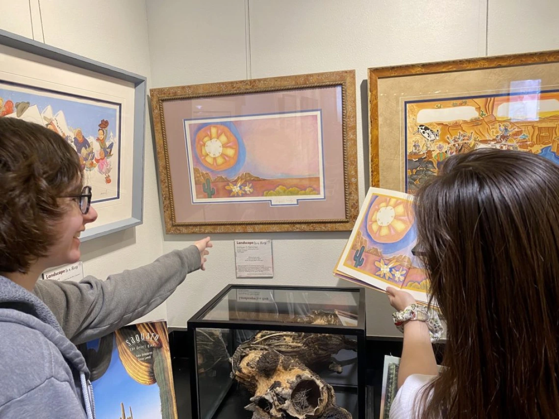 two adults looking at artwork on the wall