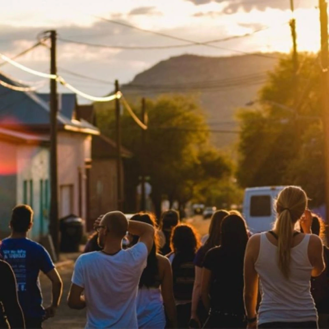 border sunset with people walking in the street