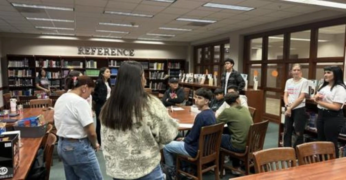 group of students and educators gathered in a library