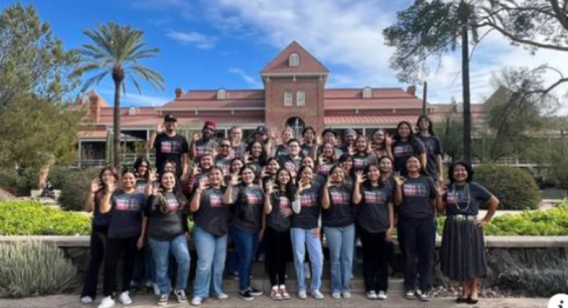 native soar group photo standing in front of old main on ua campus under a sunny sky