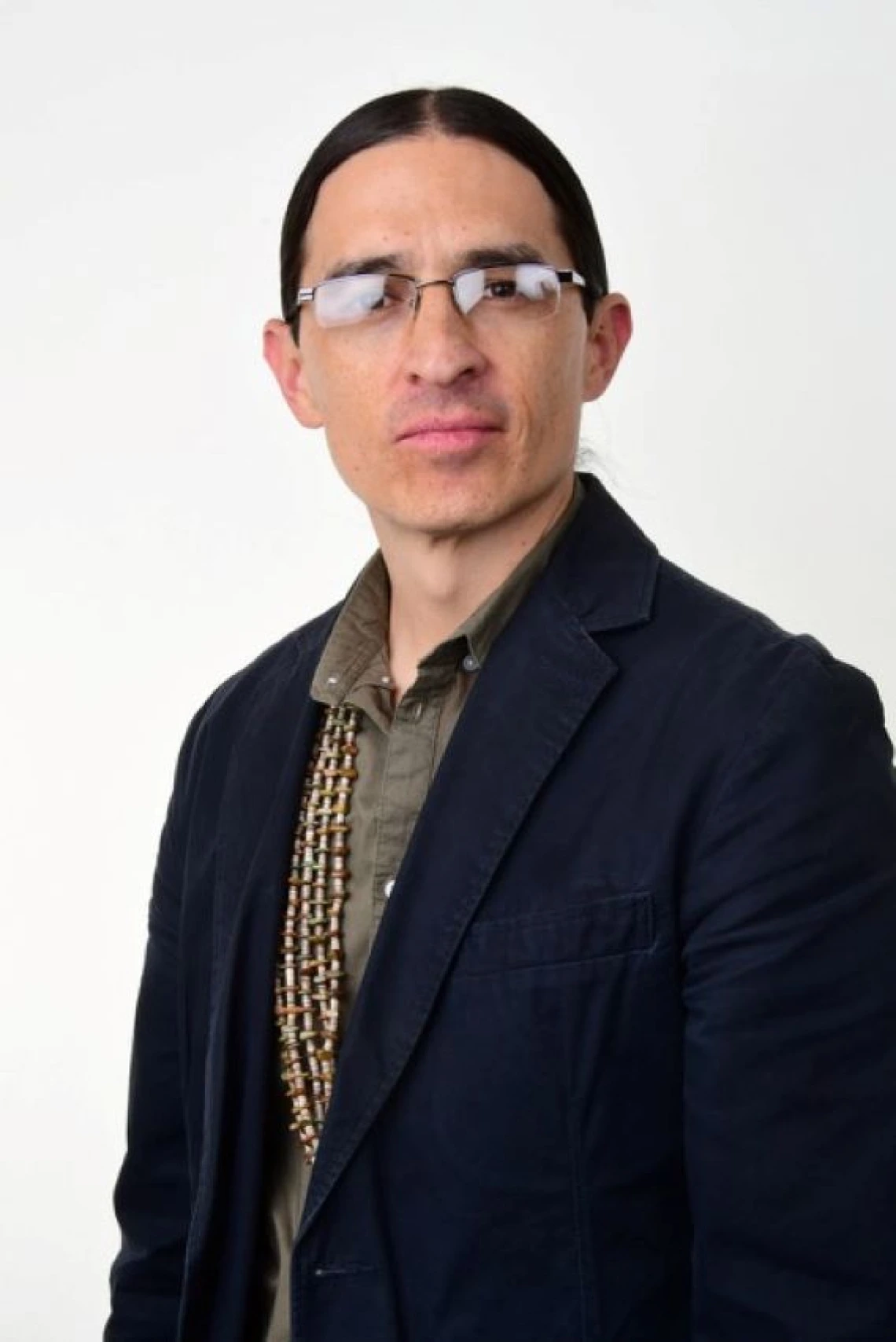 james mckenzie headshot, wearing eyeglasses, dark blazer, white background