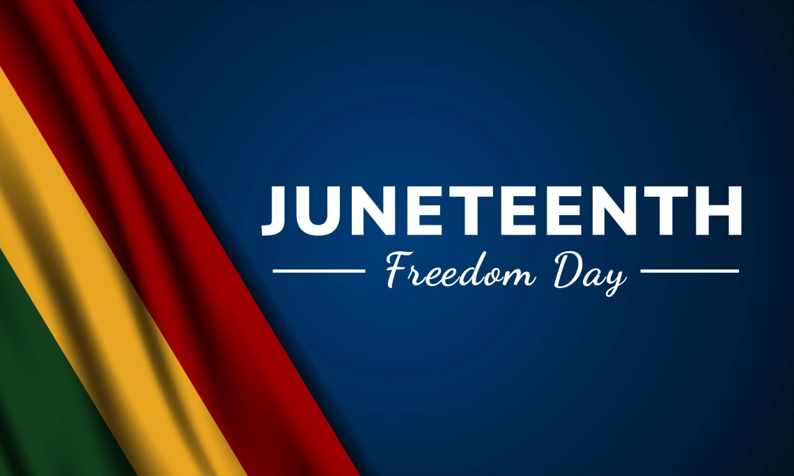 Graphic with a dark blue background featuring the words ‘JUNETEENTH’ in bold white capital letters and ‘Freedom Day’ in white cursive below. On the left side, red, gold, and green vertical stripes evoke the Pan-African flag colors.