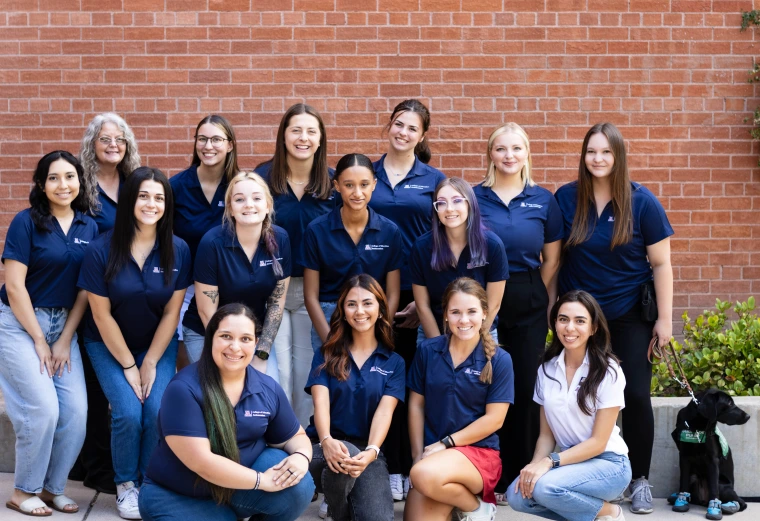 2023 COE ambassadors group picture, outside photo with brick background