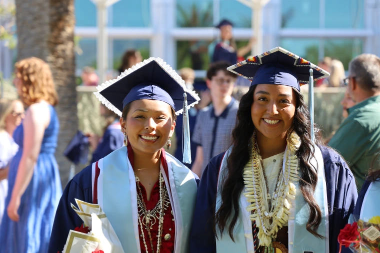 Two native students in their caps and gowns