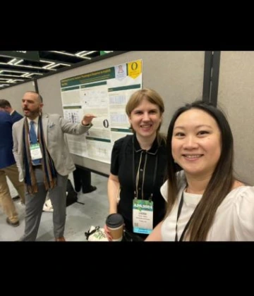 selfie in front of poster presentation at APA 2024 meeting